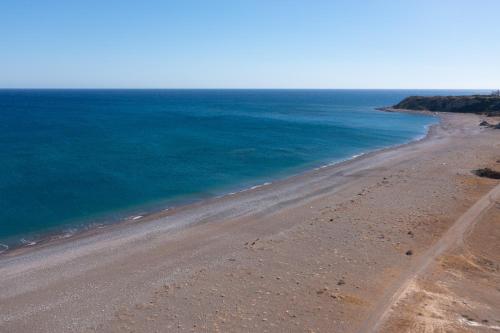 an aerial view of a beach with the ocean at Southrock Villas in Lachania