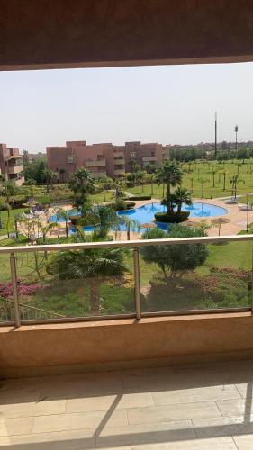 a view of a park from a window at Prestigia jade Marrakech ENTREE 191 APPARTEMENT 9 in Marrakech