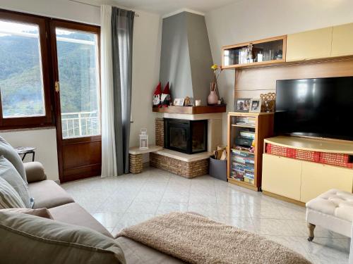 a living room with a television and a fireplace at Sunrise apartament in Monterosso al Mare