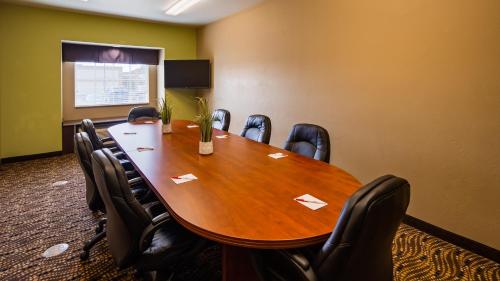 a conference room with a wooden table and chairs at SureStay Plus Hotel by Best Western Buckhannon in Buckhannon