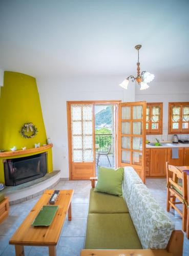 a living room with a couch and a fireplace at Olive House in Damouchari with a sea view - Delicious Houses in Damouchari