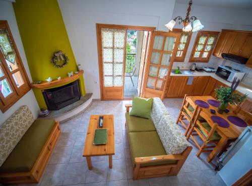 a living room with a couch and a table at Olive House in Damouchari with a sea view - Delicious Houses in Damouchari