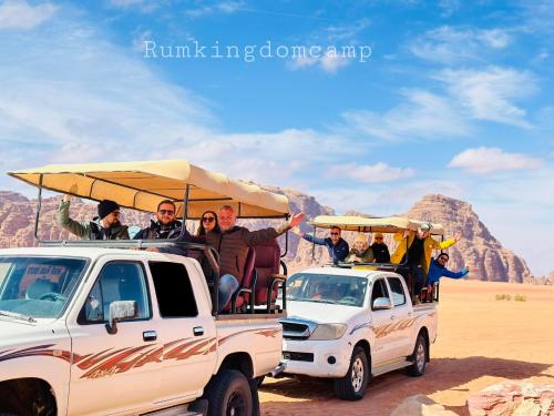 a group of people riding in the back of a truck at Rum Kingdom Camp in Wadi Rum