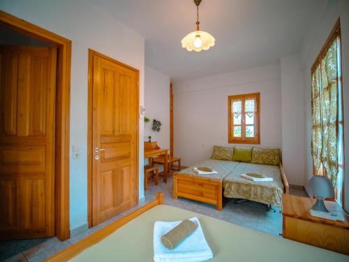 a living room with a couch and a table at Olive House in Damouchari with a sea view - Delicious Houses in Damouchari