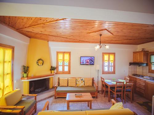 a living room with a couch and a table at Lemon House for big family in Damouchari - Delicious Houses in Damouchari