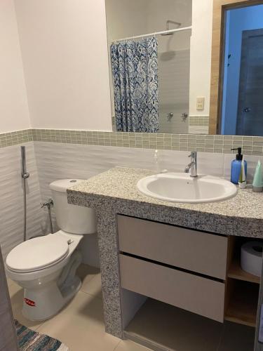 a bathroom with a toilet and a sink at Vistalu - Amazing View Beach Apartment in Playas