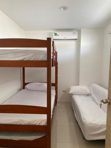 a room with two bunk beds and a window at Vistalu - Amazing View Beach Apartment in Playas