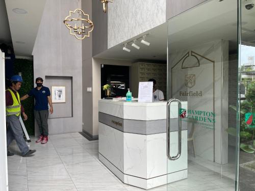 two men standing at a counter in a building at The Cozy Place Condo in Pasig Phil in Manila