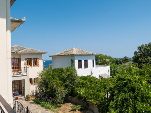 a house on a hill with trees at Olive House in Damouchari with a sea view - Delicious Houses in Damouchari