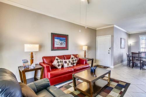 a living room with a red couch and a table at Dawn 625 in Galveston