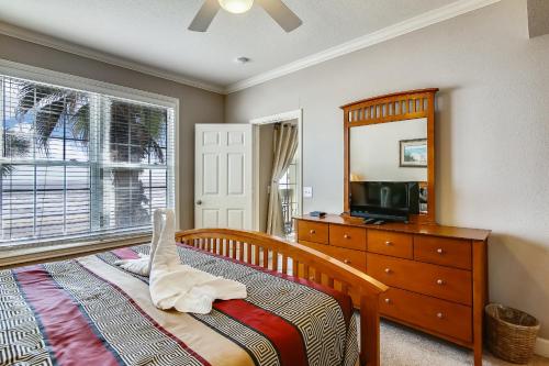 a bedroom with a bed and a dresser and a mirror at Dawn 625 in Galveston