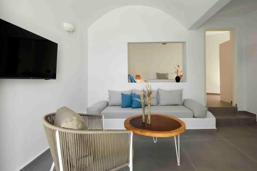 a living room with a couch and a table at Marizan Caves & Villas in Oia