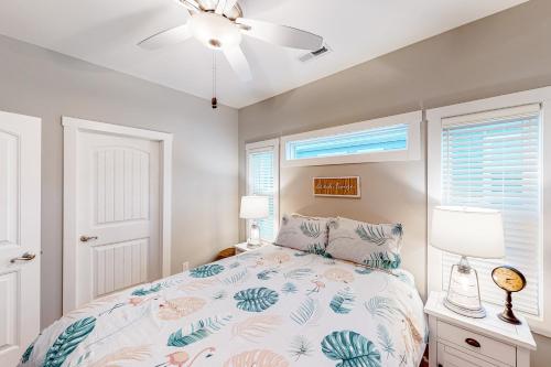 a bedroom with a bed and a ceiling fan at Sea N Red - upper in Oak Island