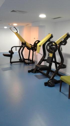a gym with two tread machines in a room at Captain Pier Hotel in Protaras