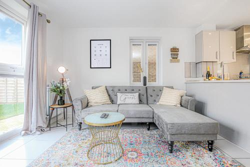 a living room with a couch and a table at Alpha Properties 1 - Luxury One Bedroom within a Shared Four Bedroom House with Free Parking, Fast Wifi, SmartTV with Netflix in Milton Keynes