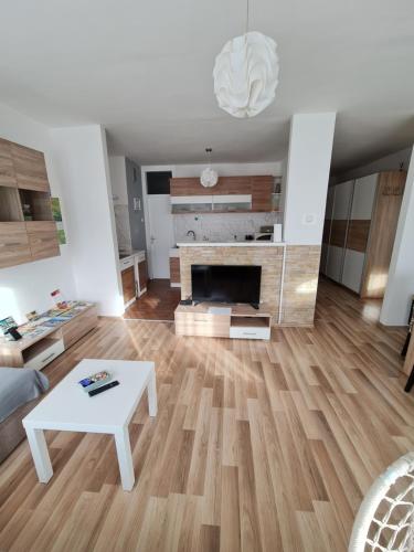 a living room with a table and a fireplace at Apartment Pemper - Self check in and check out in Otočac