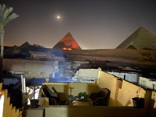 a view of the pyramids of giza at night at Pyramids Lounge Guest House in Cairo