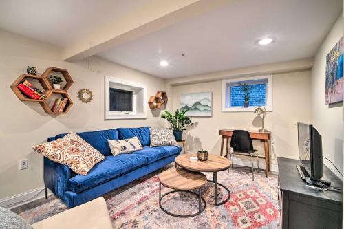 a living room with a blue couch and a table at Washington DC Apartment at Rock Creek Park! in Washington, D.C.