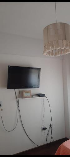 a flat screen tv hanging on a white wall at Hermoso departamento Tucuman in San Miguel de Tucumán