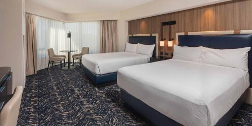 a hotel room with two beds and a table at Caesars Republic Lake Tahoe in Stateline