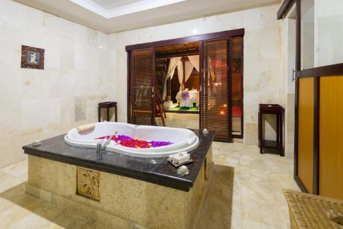 a bathroom with a large bath tub in a room at One Bedroom Private Pool Kuta in Kuta