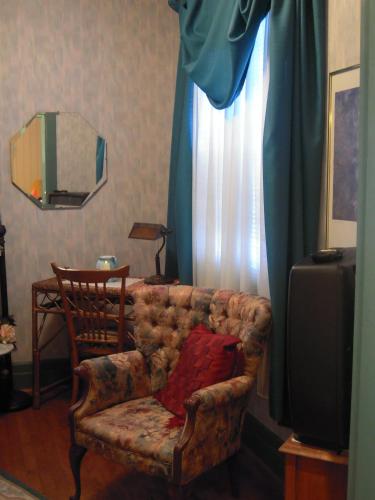a living room with a couch and a television at L'Arvidienne Couette et Café in Quebec City