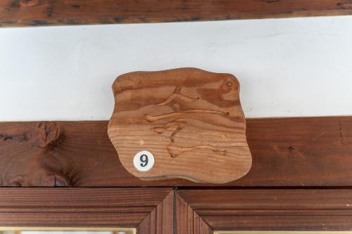 a wooden cutting board with the number eight on it at Sarangroo in Jeonju