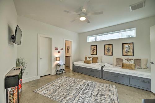 a bedroom with two beds and a ceiling fan at Downtown Houston Townhome with Balcony and Yard! in Houston