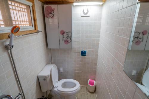 a small bathroom with a toilet and a shower at Sarangroo in Jeonju