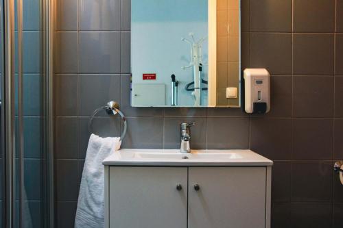 a bathroom with a sink and a mirror at Hannah's Studios in Porto