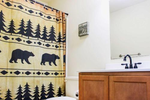 a bathroom with a shower curtain with bears on it at Walk to Beach Beautiful Lake Naomi Retreat! in Pocono Pines