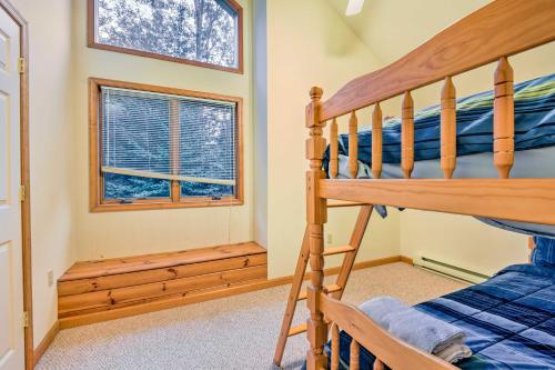 a bedroom with a bunk bed and a window at Walk to Beach Beautiful Lake Naomi Retreat! in Pocono Pines