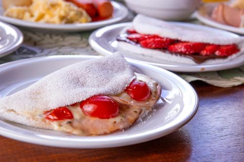 a white plate with a dessert on a table at Hotel Praia do Portinho in Ilhabela