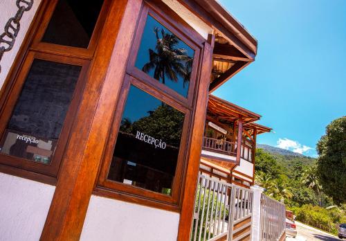 a window of a building with a reflection in it at Hotel Praia do Portinho in Ilhabela