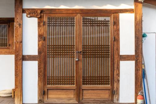 an old wooden door on a wall at Sarangroo in Jeonju
