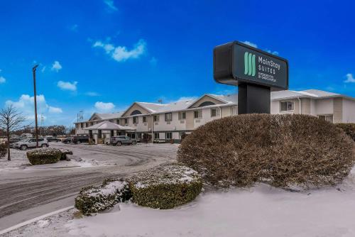 a sign in the snow in front of a building at MainStay Suites Joliet I-80 in Joliet