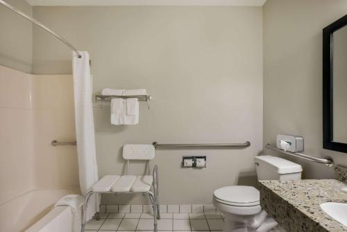a white bathroom with a toilet and a sink at MainStay Suites Joliet I-80 in Joliet