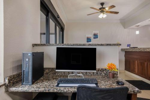 a computer on a desk with a keyboard and a monitor at MainStay Suites Joliet I-80 in Joliet