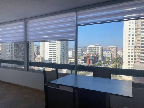 a table in a room with a view of a city at Apartamento en Viña del Mar in Viña del Mar