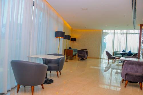 a waiting room with chairs and a table and a table and chairs at Radisson Blu Hotel, Juba in Juba