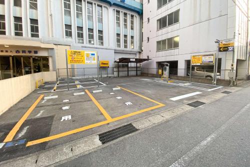 an empty parking lot in front of a building at Comfort Hotel Yokkaichi in Yokkaichi