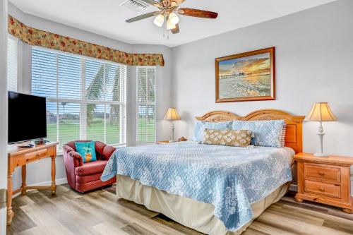 a bedroom with a bed and a flat screen tv at Fairway Vista in Naples