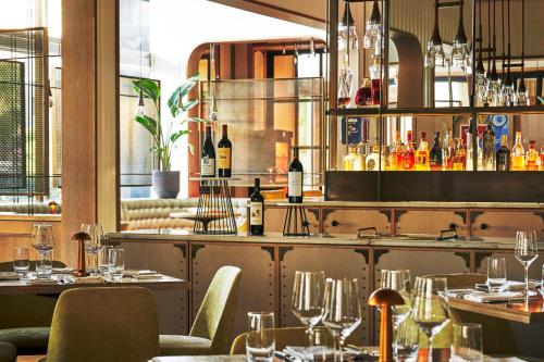 a restaurant with tables and chairs with wine glasses at Four Seasons Hotel Miami in Miami
