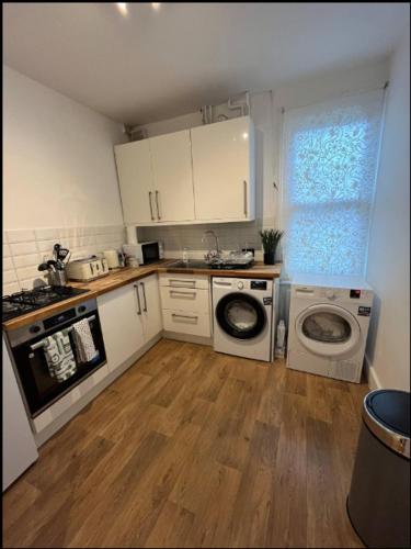 a kitchen with two washing machines and a washer at Two Bedroom Apartment in London in London