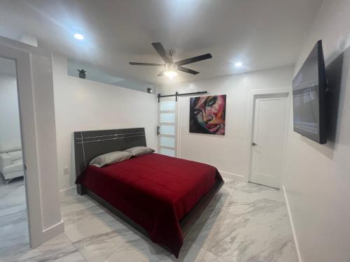 a bedroom with a red bed and a ceiling fan at Villa San Carlos Park in Fort Myers