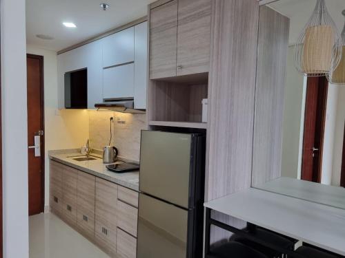 a kitchen with a refrigerator and a counter top at Amazing view 2 bedrooms new apartment in Batam Center