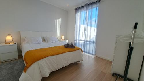 a bedroom with a large bed and a large window at Hamilton House in Vila Franca do Campo