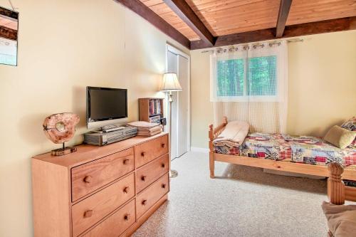 a bedroom with a bed and a television on a dresser at Conway Area Chalet with Mountain Views and Fire Pit! in Madison