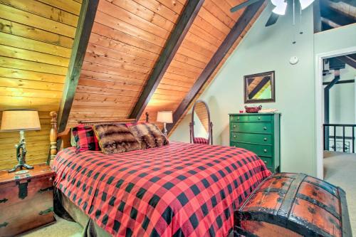 a bedroom with a bed and a wooden ceiling at Conway Area Chalet with Mountain Views and Fire Pit! in Madison