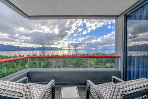 a balcony with a view of the water and mountains at Caesars Republic Lake Tahoe in Stateline